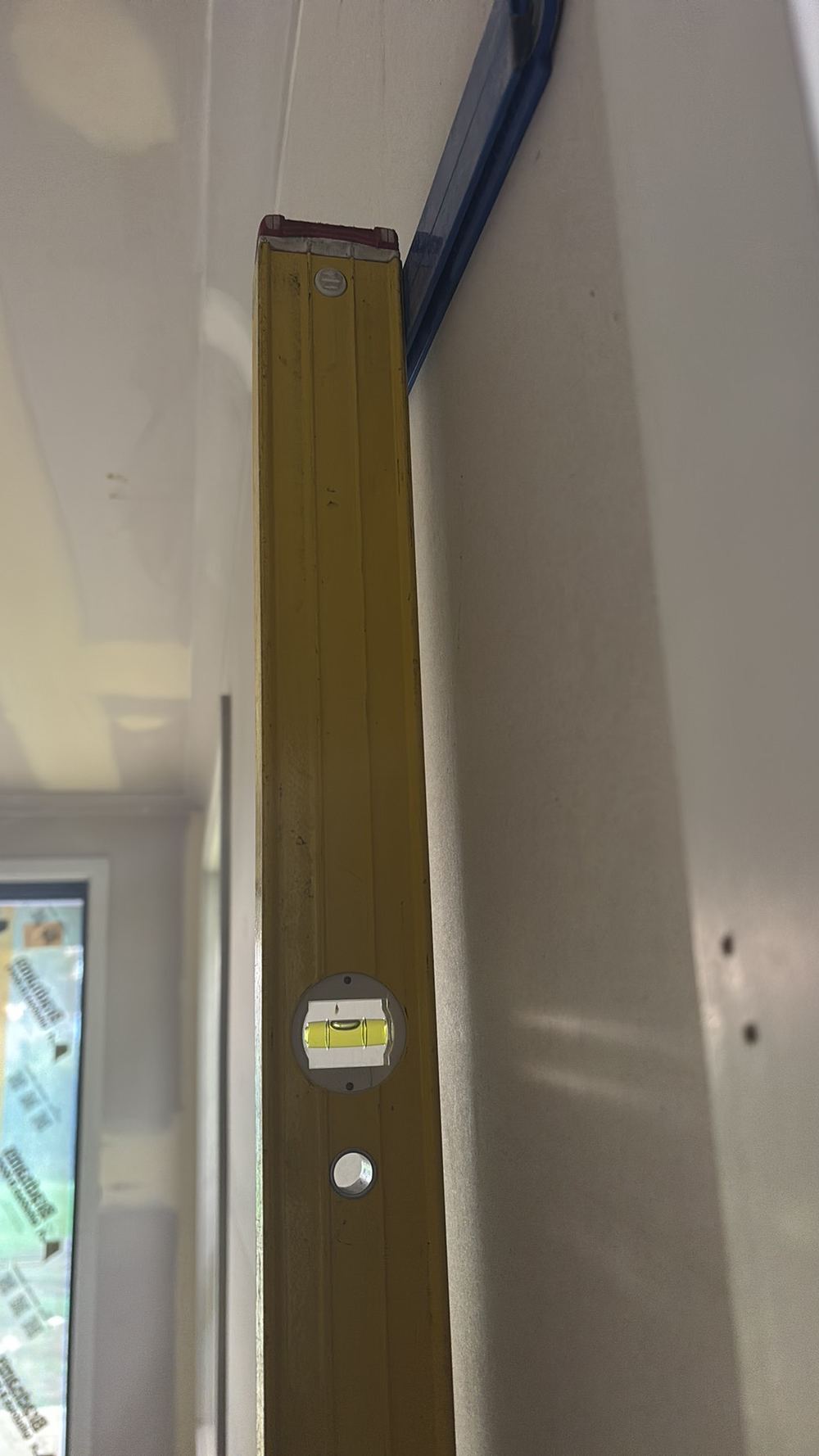 Wall more than 5mm out of plumb over a 1.8m straight edge, found during a fixing inspection in Hoppers Crossing