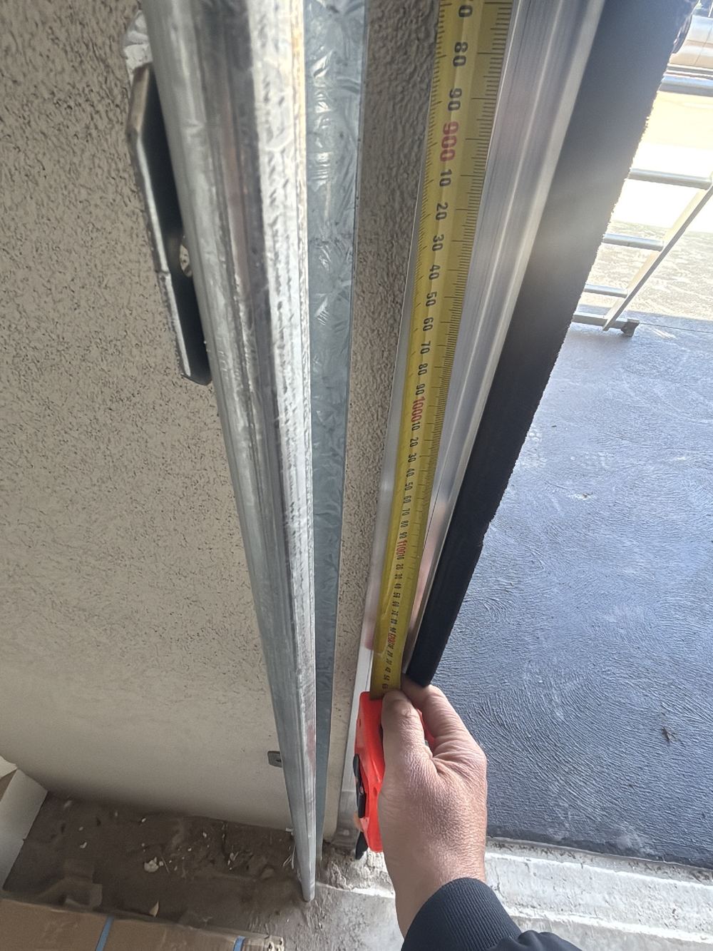 Garage door brush seal loose and striking the door as it runs, found during a pre-handover inspection in Wyndham Vale