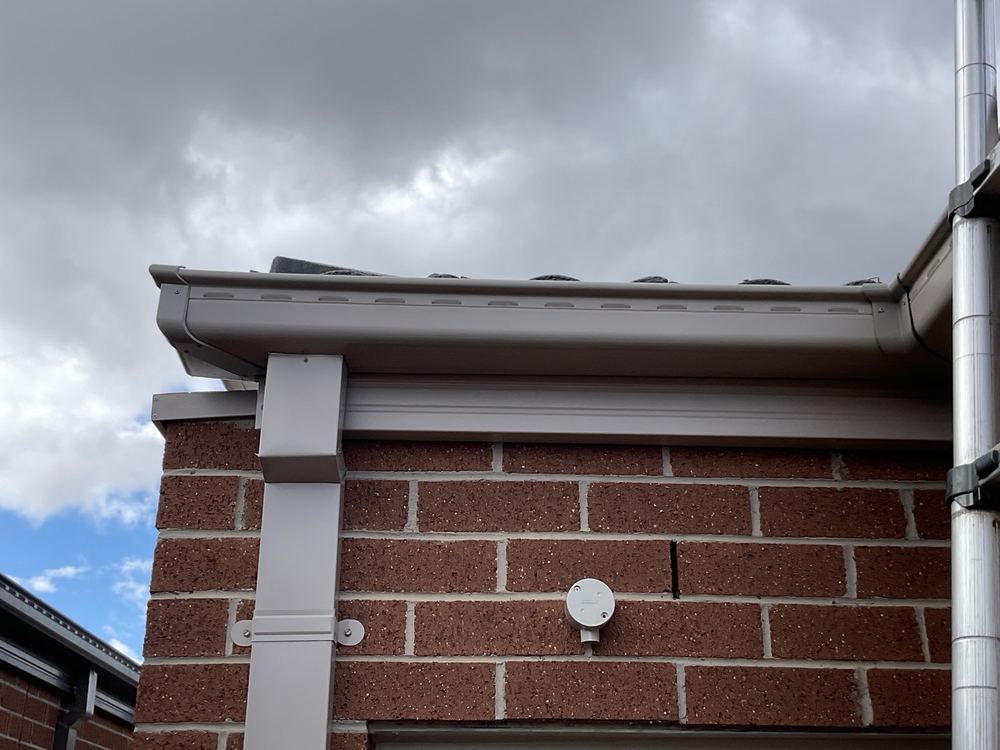 Water lying in the gutter because it lacks enough fall to the outlet, found during a pre-handover inspection in Wyndham Vale