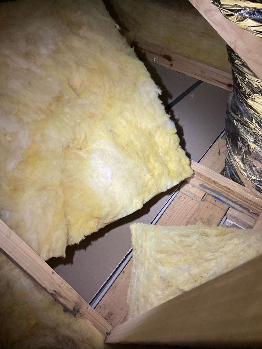 Ceiling insulation batts pushed out of place, leaving bare patches, found during a pre-handover inspection in Wyndham Vale