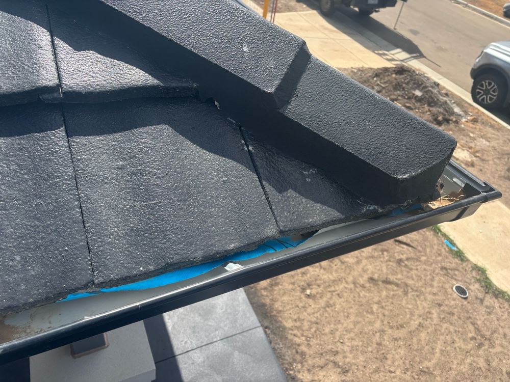 Sarking running past the roof edge and needing to be cut back, found during a pre-handover inspection in Wyndham Vale