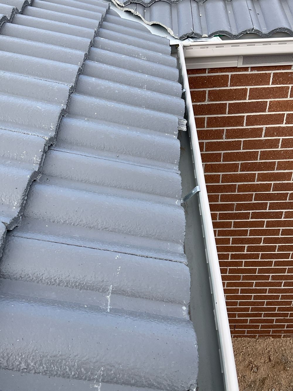 Roof tiles overhanging the gutter by more than the 65mm allowed, found during a pre-handover inspection in Wyndham Vale