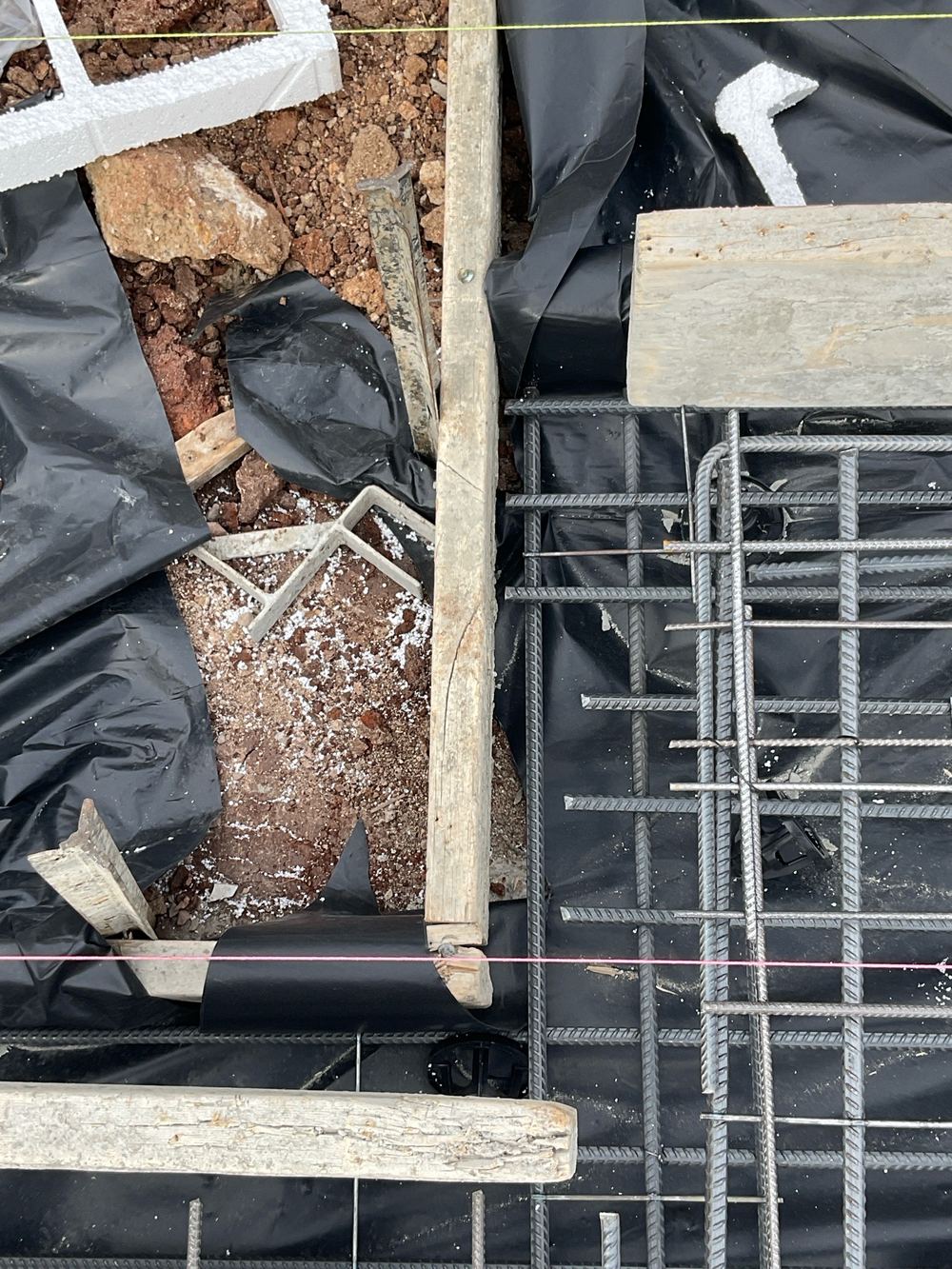 Vapour barrier stopping short of the full slab and beam area, found during a slab pre-pour inspection in Hoppers Crossing